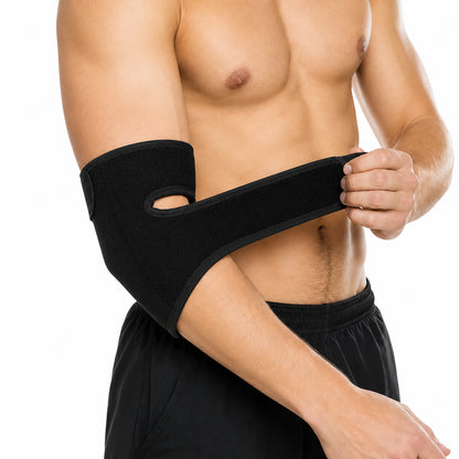 Justerbart svart armbågsskydd med kardborrerem och följsam passform runt armbågen.