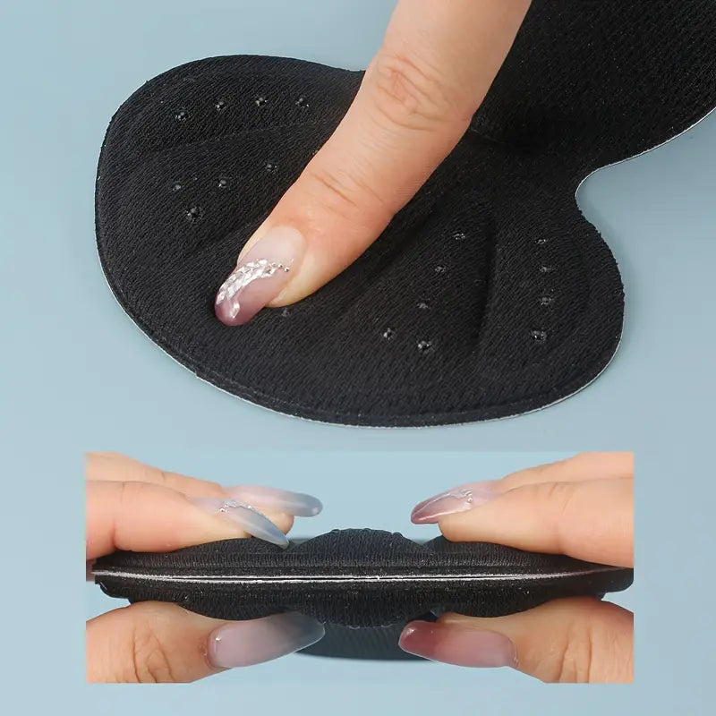 T-formad hälkudde i svart – mjuk, självhäftande design som skyddar hälen.